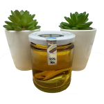 A glass jar filled with 95% minimum THC distillate, surrounded by two small green succulent plants.