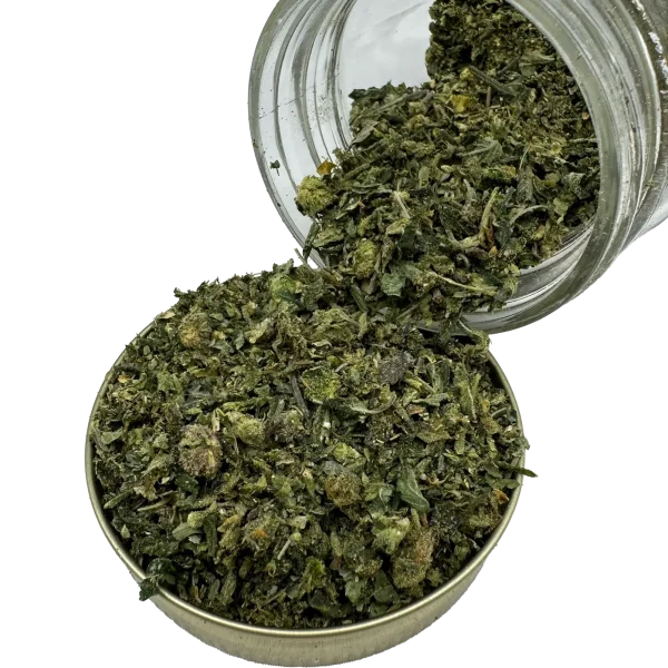 Close-up of Rockstar Shake cannabis blend in a metal tin with glass jar tipped over