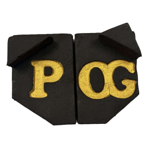 Rich, handcrafted Pineapple OG Hash blocks with a deep black surface and gold-embossed ‘P OG’ markings.