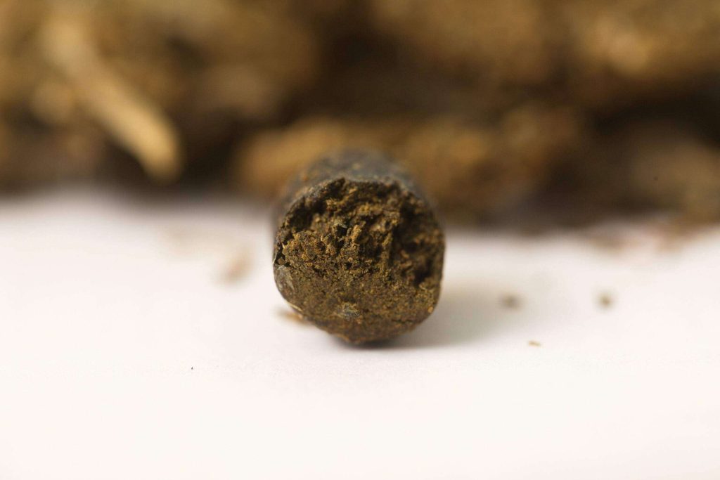 Close-up of dark, resin-rich hash showcasing its dense texture and deep color.